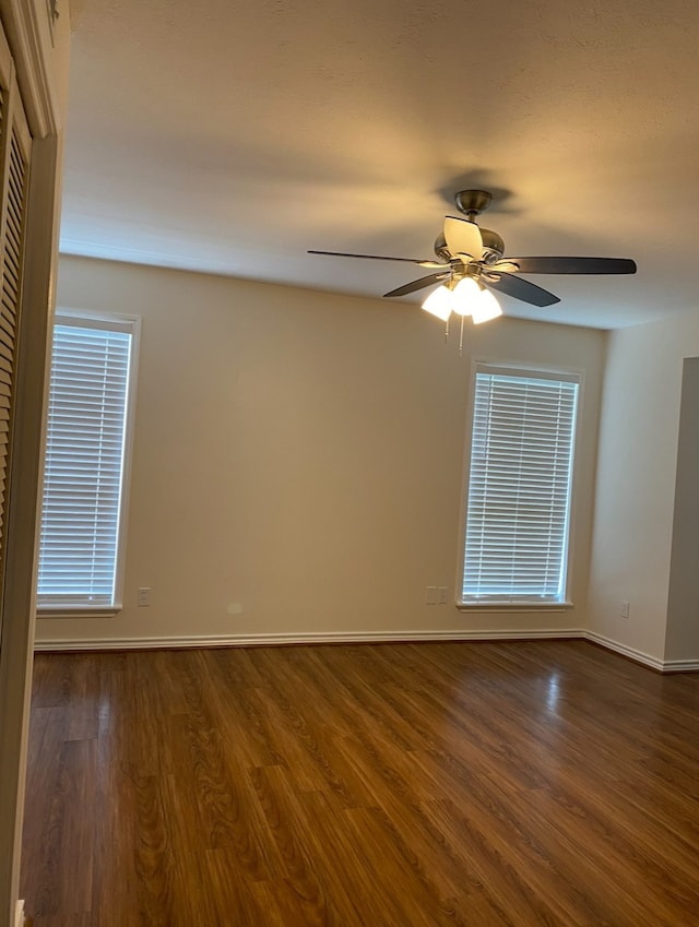 spare room with hardwood / wood-style flooring and ceiling fan