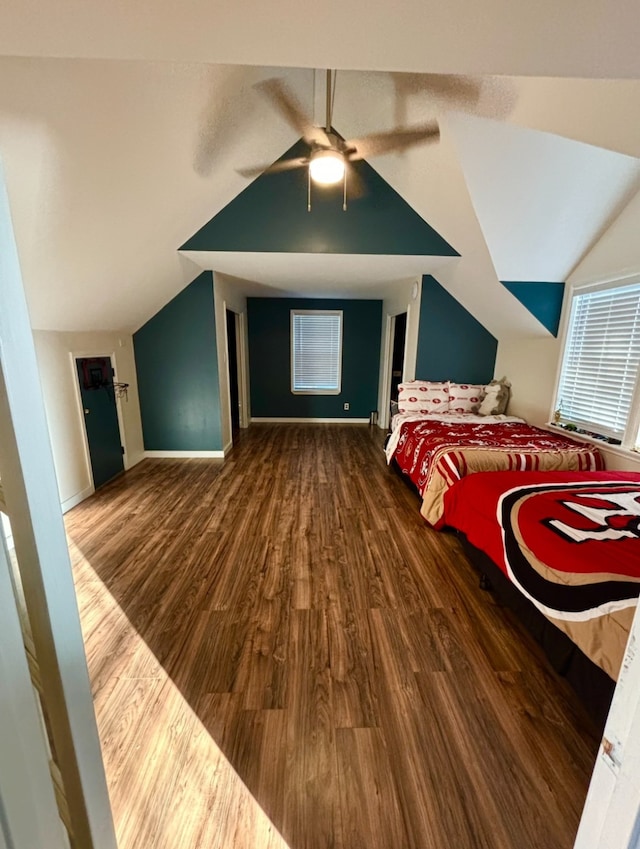 interior space featuring ceiling fan, lofted ceiling, and dark hardwood / wood-style floors