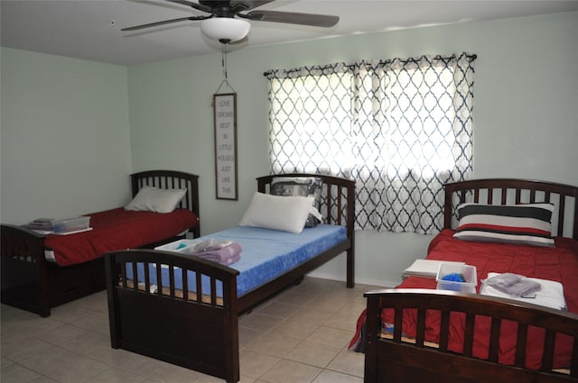 bedroom with ceiling fan and light tile patterned flooring