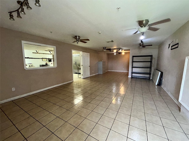 3315 Fm 523rd Rd, Oyster Creek, TX 77541 - unfurnished room with light tile patterned flooring, a ceiling fan, rail lighting, and baseboards