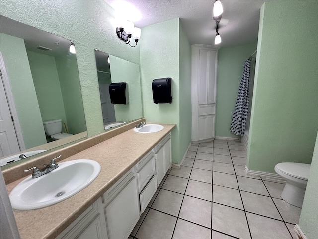 3315 Fm 523rd Rd, Oyster Creek, TX 77541 - full bathroom with toilet, tile patterned flooring, and a sink