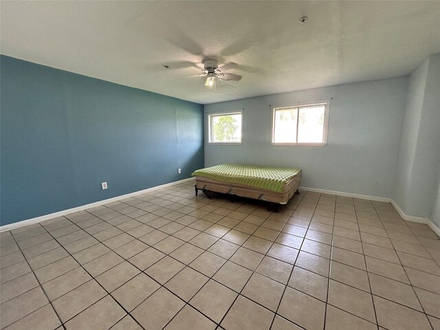 3315 Fm 523rd Rd, Oyster Creek, TX 77541 - bedroom featuring baseboards, light tile patterned floors, and ceiling fan