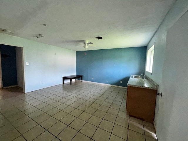 3315 Fm 523rd Rd, Oyster Creek, TX 77541 - empty room featuring light tile patterned floors, a ceiling fan, a textured ceiling, and a sink