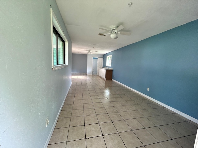 3315 Fm 523rd Rd, Oyster Creek, TX 77541 - empty room with light tile patterned floors, a ceiling fan, and baseboards
