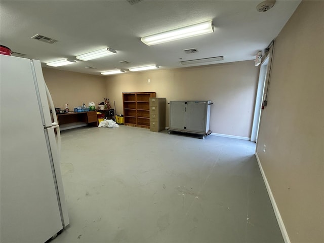 3315 Fm 523rd Rd, Oyster Creek, TX 77541 - basement featuring baseboards, visible vents, and freestanding refrigerator