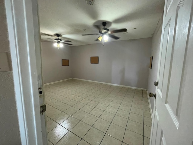 3315 Fm 523rd Rd, Oyster Creek, TX 77541 - empty room with light tile patterned flooring, a ceiling fan, baseboards, and a textured ceiling
