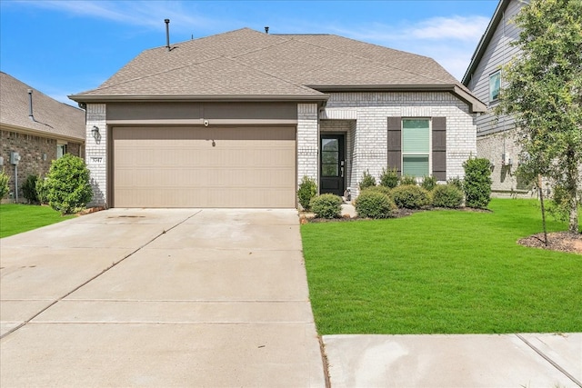 view of front of home with a garage and a front lawn