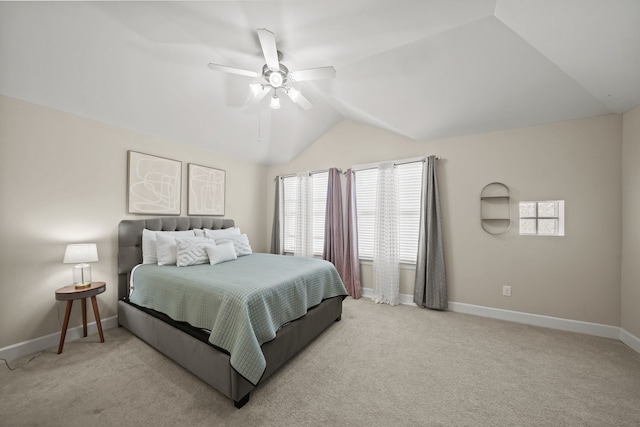 bedroom with ceiling fan, vaulted ceiling, and light carpet