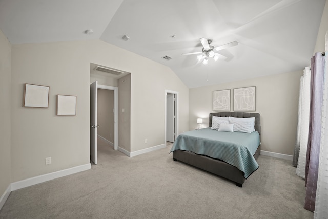 bedroom with ceiling fan, vaulted ceiling, and light colored carpet