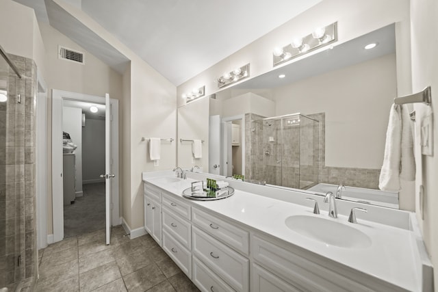 bathroom with tile patterned floors, double vanity, a shower with door, and lofted ceiling