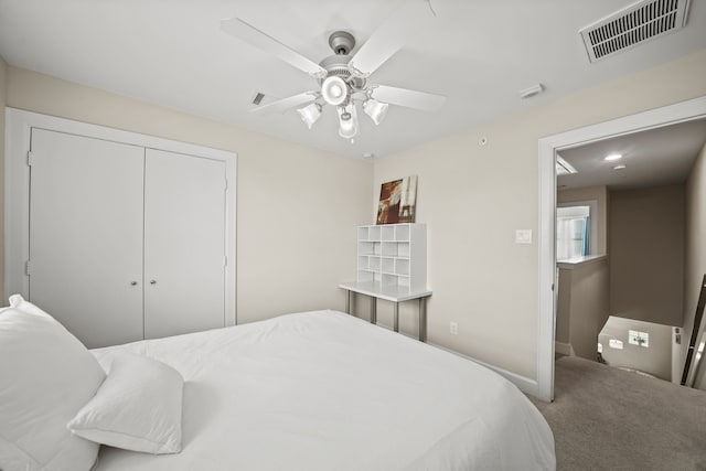 bedroom with a closet, ceiling fan, and carpet