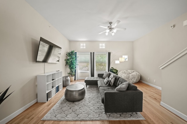 living room featuring ceiling fan and light hardwood / wood-style flooring