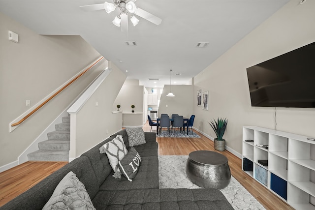 living room with hardwood / wood-style flooring and ceiling fan