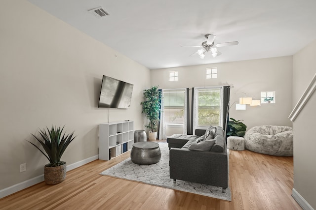 living room with ceiling fan and light hardwood / wood-style flooring