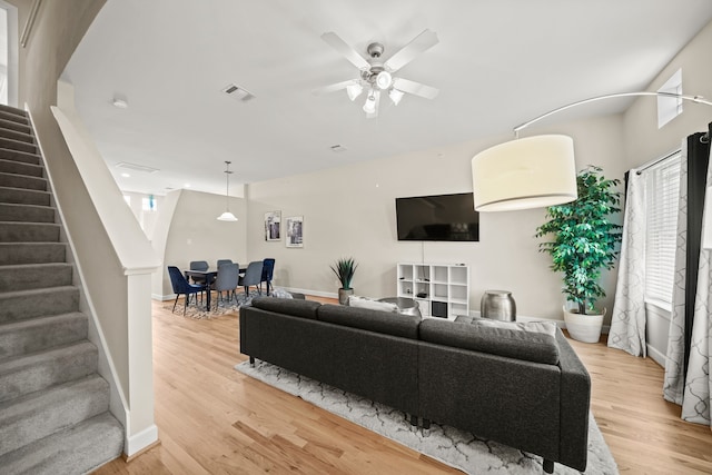 living room with light wood-type flooring and ceiling fan