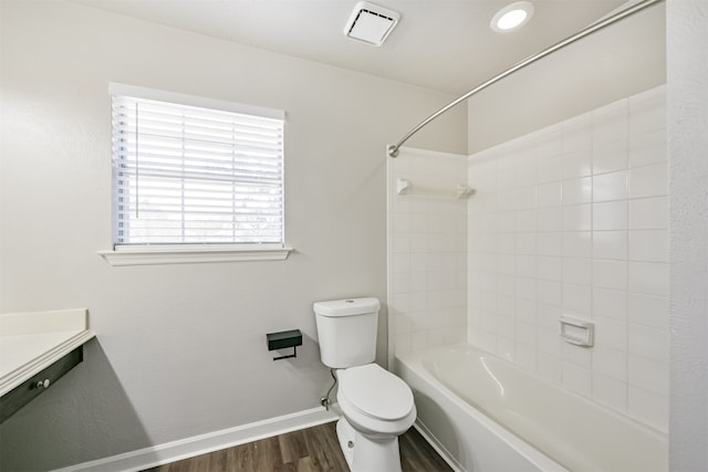 full bathroom featuring tiled shower / bath, toilet, hardwood / wood-style floors, and vanity