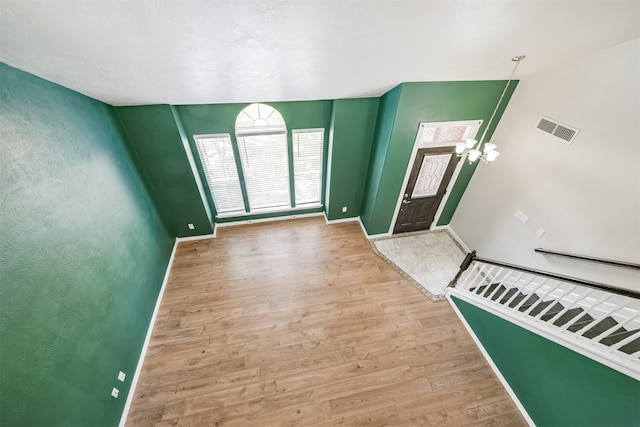 entryway featuring a high ceiling and light hardwood / wood-style flooring