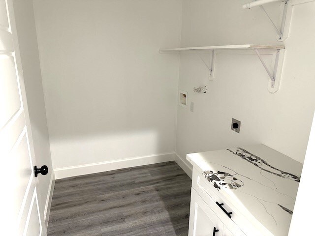 washroom featuring hookup for a washing machine, electric dryer hookup, and dark wood-type flooring