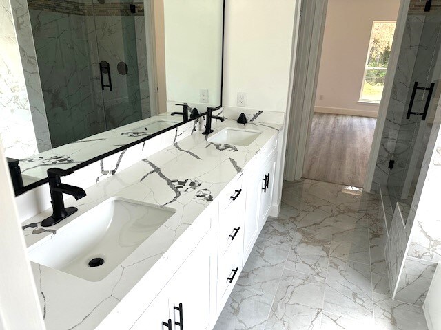 bathroom with vanity and a shower with shower door