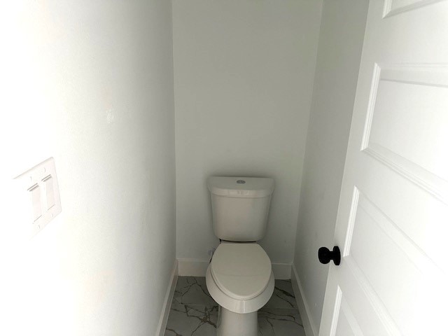 24629 Waterford St, Hempstead, TX 77445 - bathroom with toilet, marble finish floor, and baseboards