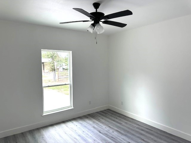 unfurnished room with wood-type flooring and ceiling fan