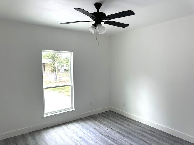 24629 Waterford St, Hempstead, TX 77445 - spare room with baseboards, ceiling fan, and wood finished floors