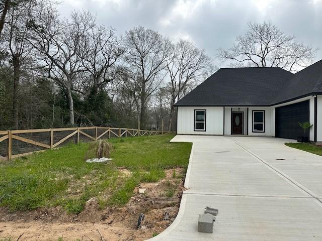 24629 Waterford St, Hempstead, TX 77445 - view of front facade with an attached garage, fence, and driveway