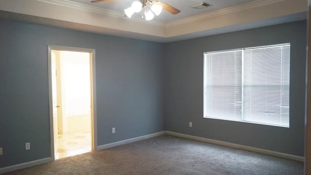 carpeted empty room with ceiling fan and crown molding