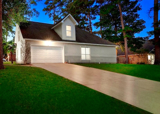 view of front facade featuring a garage and a front lawn