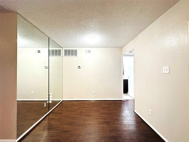 interior space with wood-type flooring and a textured ceiling