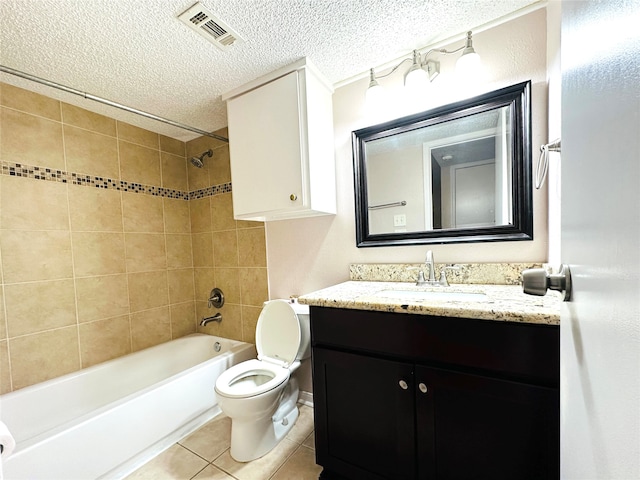 full bathroom featuring vanity, tile patterned flooring, a textured ceiling, toilet, and tiled shower / bath combo