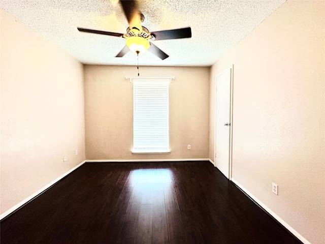 empty room with ceiling fan, a textured ceiling, and wood-type flooring