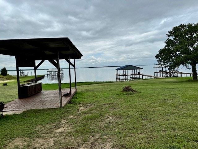 view of yard featuring a water view and a boat dock