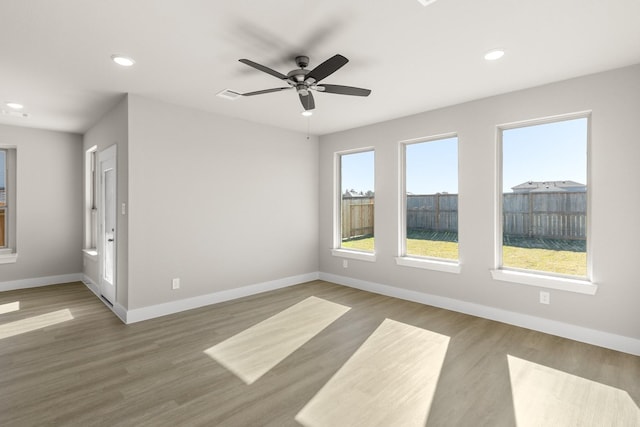 unfurnished room with ceiling fan and light wood-type flooring