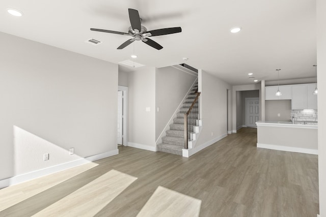 unfurnished living room featuring light hardwood / wood-style floors and ceiling fan