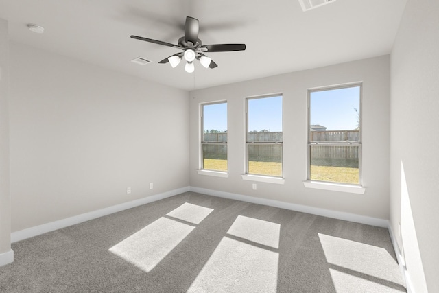 unfurnished room with plenty of natural light, ceiling fan, and carpet floors