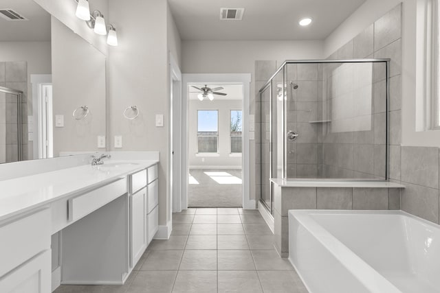 bathroom with tile patterned flooring, vanity, ceiling fan, and plus walk in shower