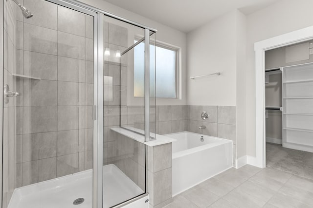 bathroom featuring tile patterned flooring and plus walk in shower