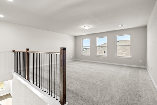 unfurnished room with light colored carpet