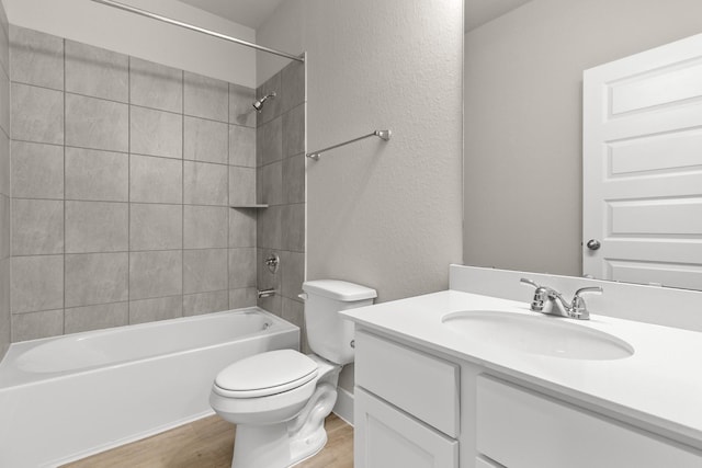 full bathroom featuring vanity, toilet, wood-type flooring, and tiled shower / bath