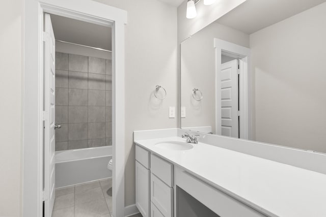 full bathroom with tile patterned flooring, vanity, toilet, and tiled shower / bath combo