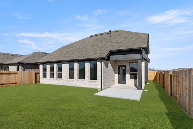 back of property featuring a yard and a patio