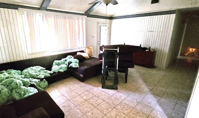 interior space with beam ceiling, ceiling fan, and tile patterned floors