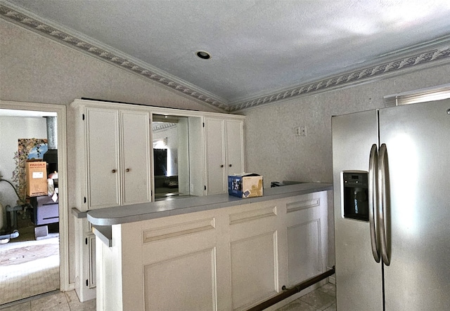 kitchen featuring stainless steel fridge, white cabinets, kitchen peninsula, crown molding, and light tile patterned flooring