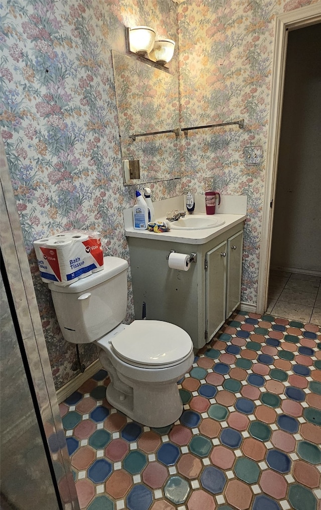 bathroom with tile patterned flooring, toilet, and vanity