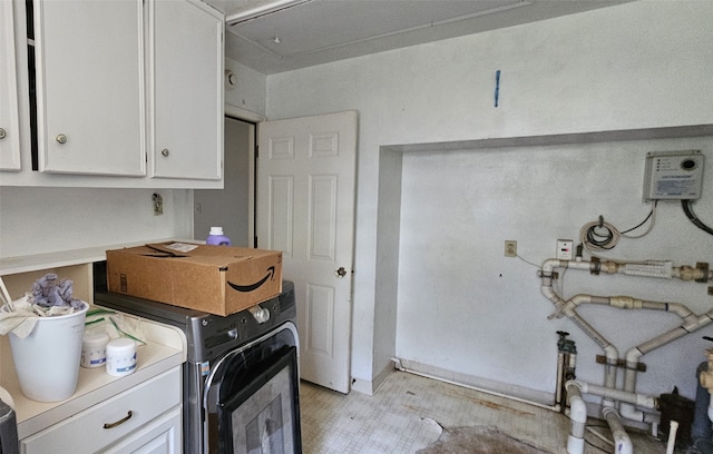 clothes washing area featuring cabinets