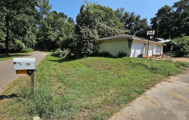 view of side of home with a lawn