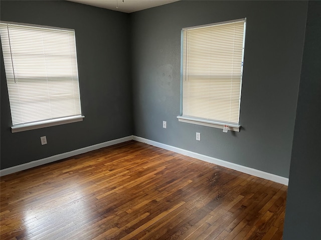 spare room with hardwood / wood-style flooring