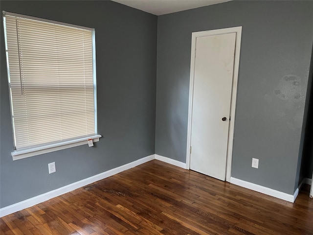 unfurnished room featuring dark hardwood / wood-style flooring