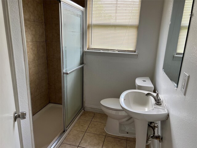 bathroom featuring sink, toilet, walk in shower, and tile patterned floors